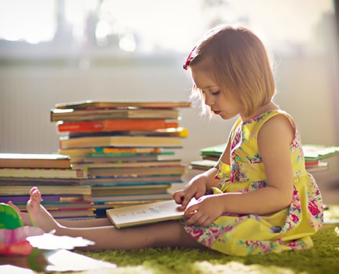 young girl child reading book books