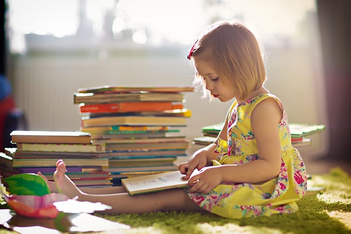 young girl child reading book books