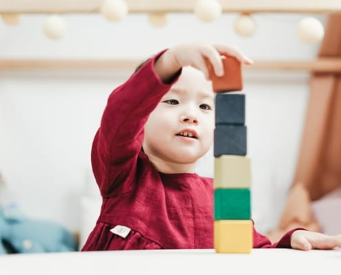 a young girl playing with blocks