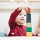 a young girl playing with blocks