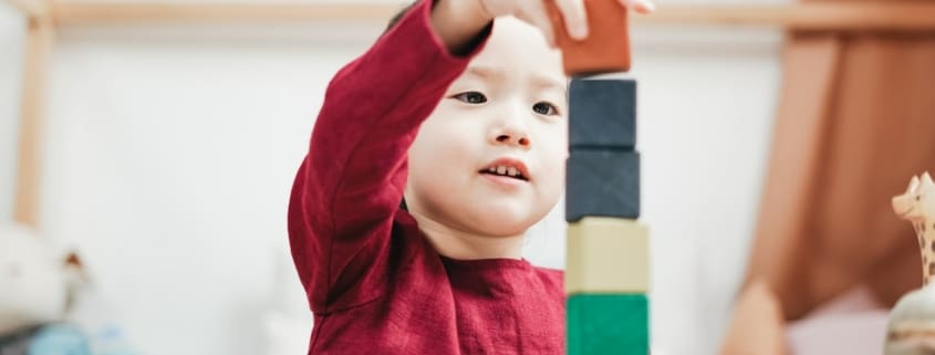 a young girl playing with blocks