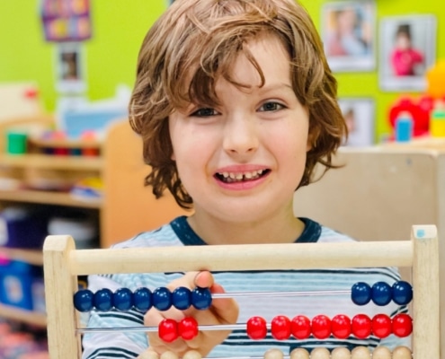 preschooler using an abacus