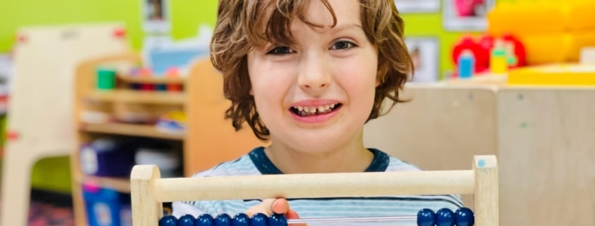 preschooler using an abacus