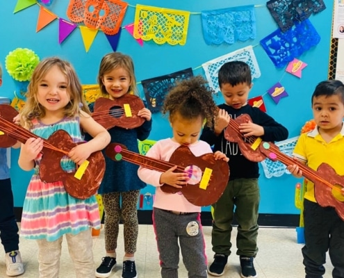 preschool kids playing mexican guitar