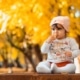 young girl sitting on a table in autumn