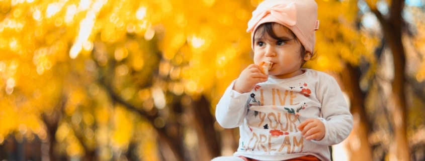 young girl sitting on a table in autumn