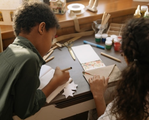 two children making winter craft ideas for kids