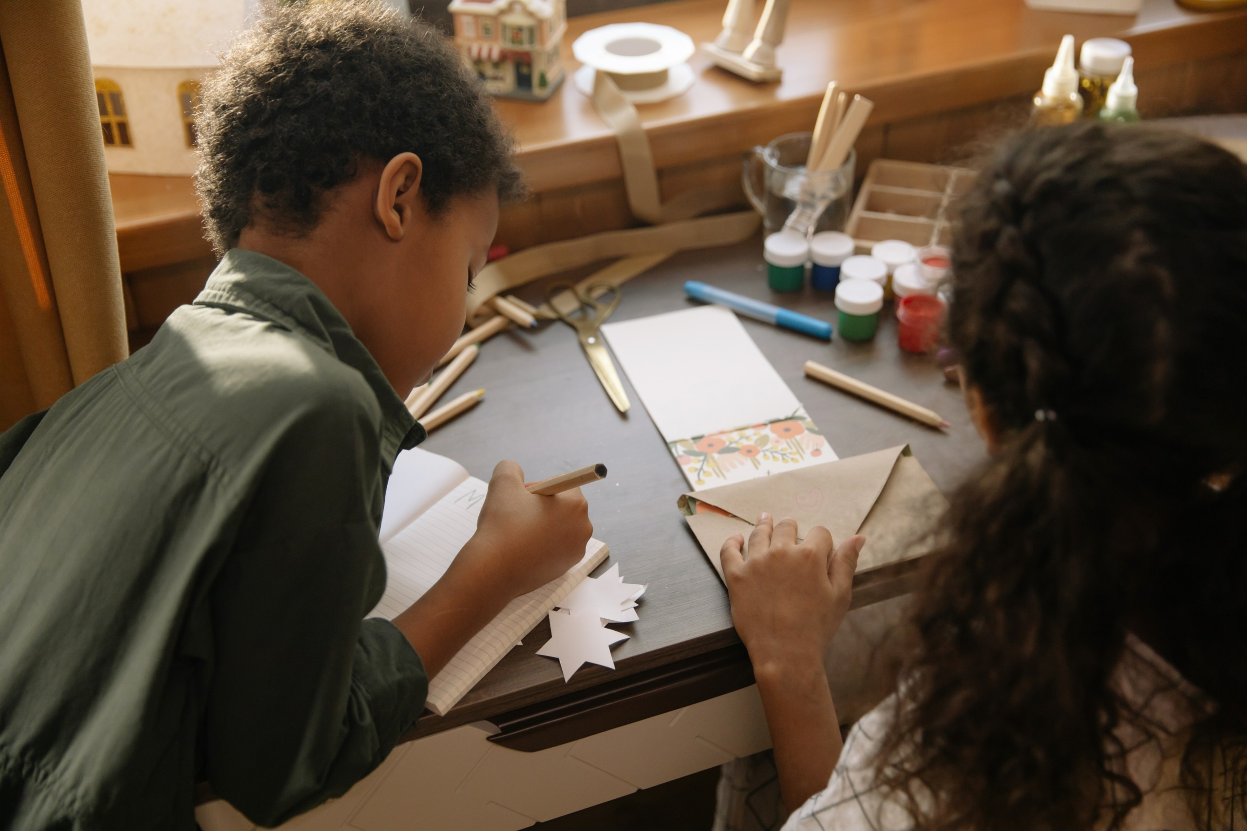 two children making winter craft ideas for kids