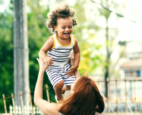 mother lifting her kid up