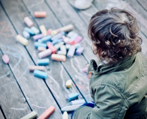 child playing with chalk for self-regulation