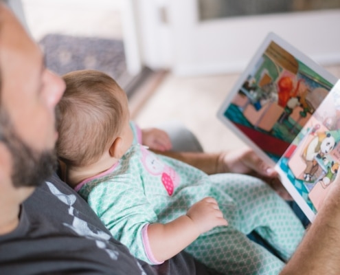 parent and toddler reading a book
