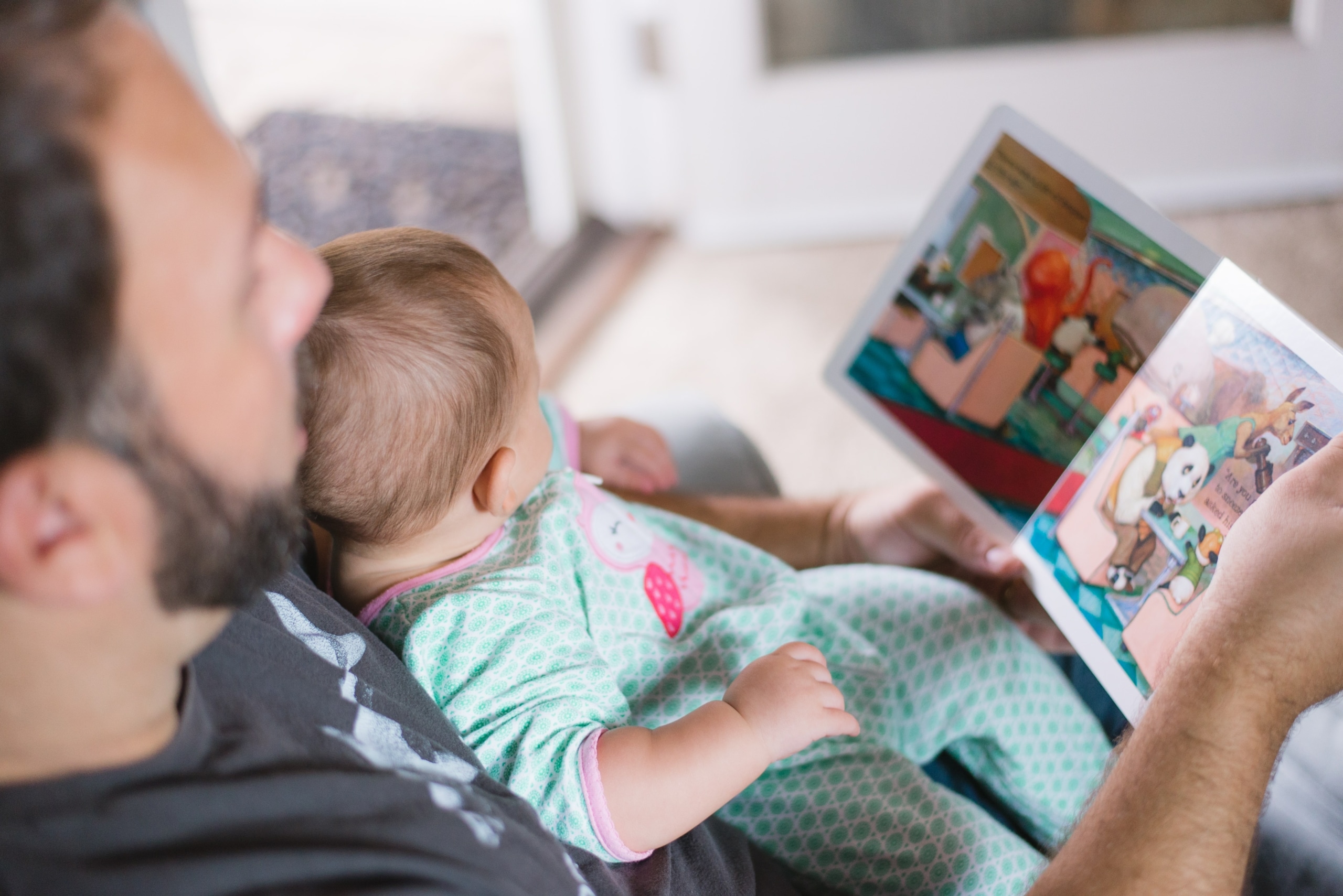 parent and toddler reading a book