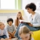 teacher reading a book to students