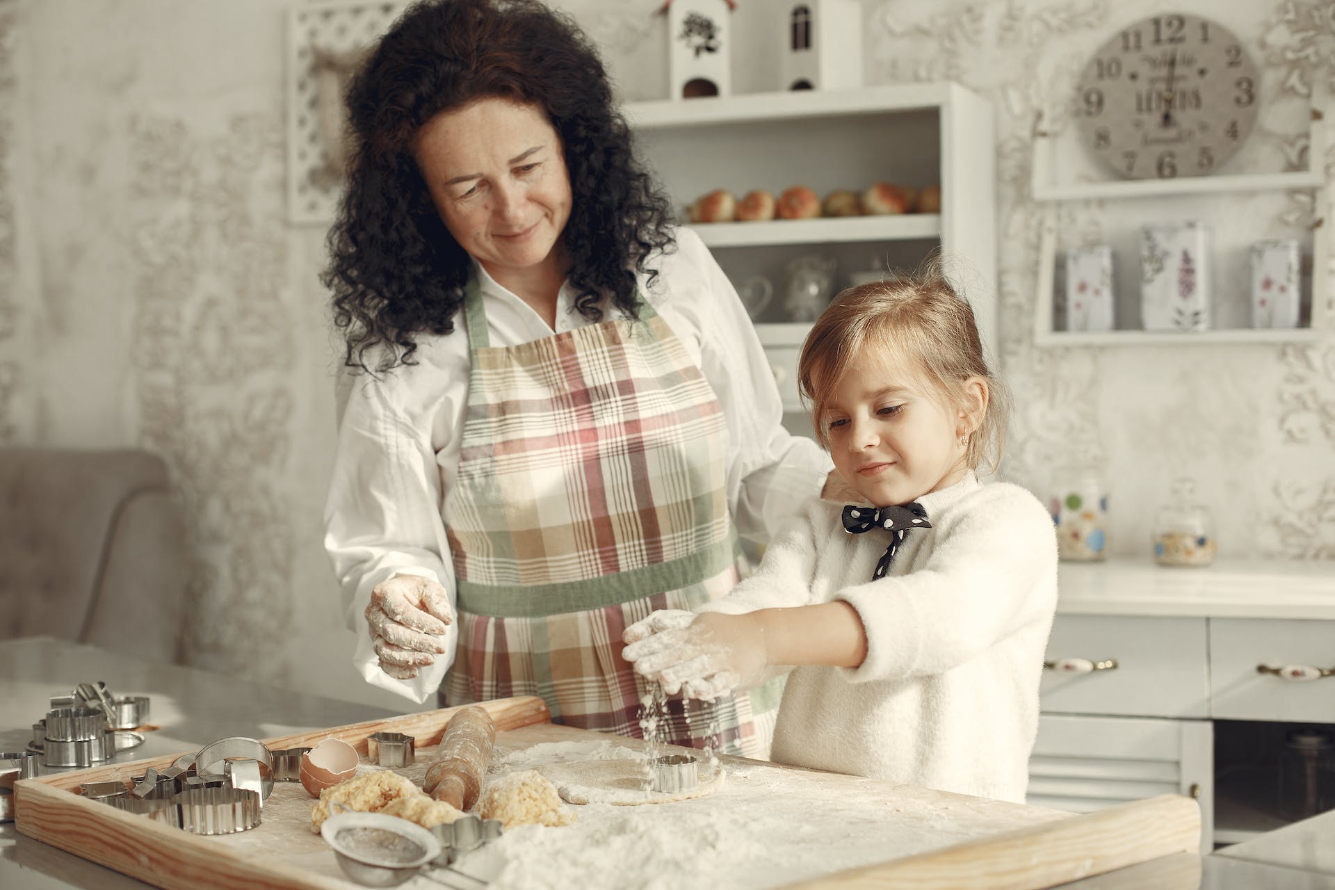 mother and child making dough in the kitchen