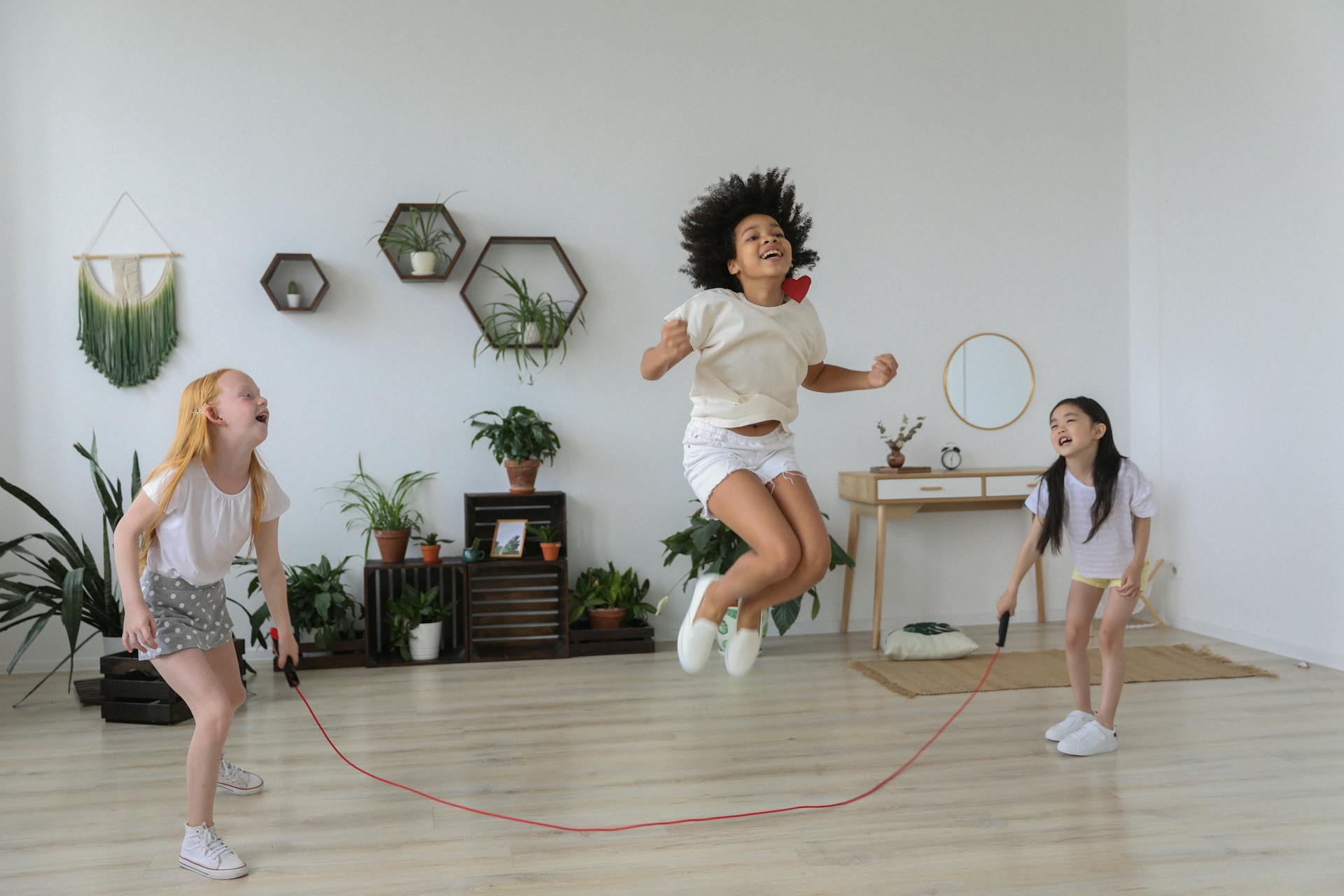 children playing jump rope indoors