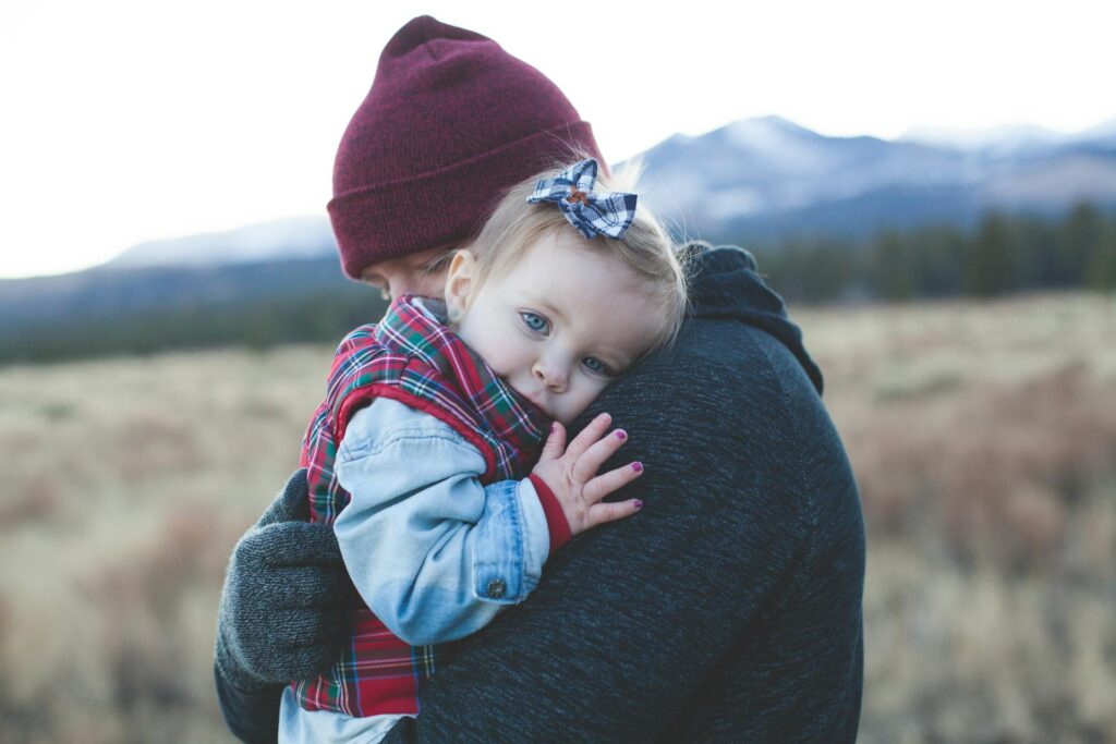Parent holding a toddler