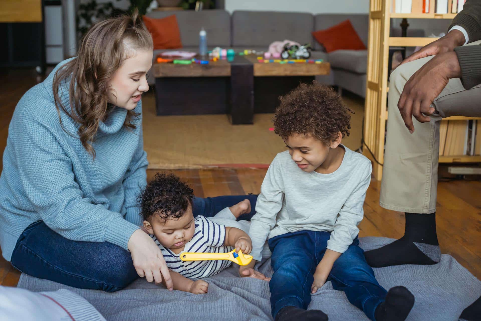 mother and son playing with a baby
